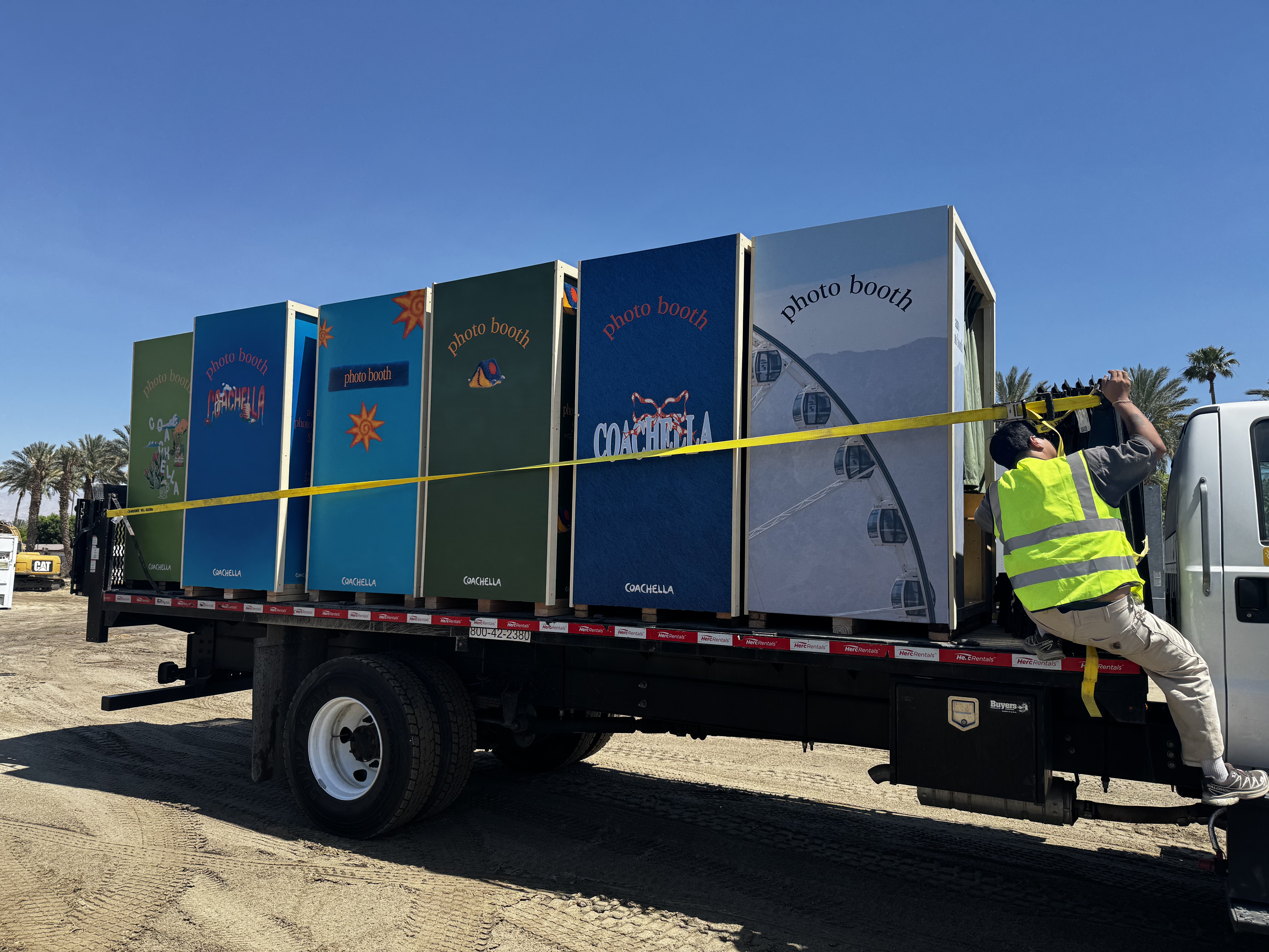 Six colorful Coachella photo booths secured on a flatbed truck